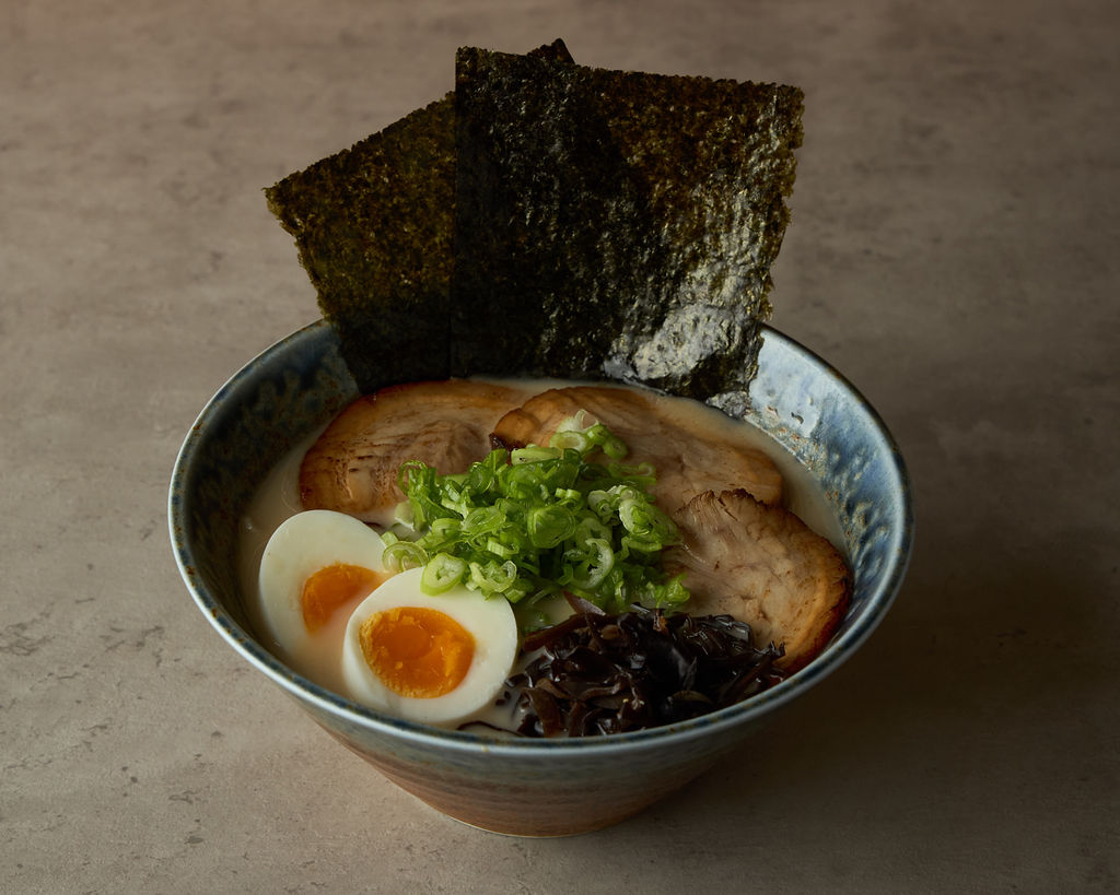 Ramen bowl in speckled blue ceramic with rich pork broth and chashu